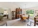 Elegant dining room featuring a wooden table, a large window with views, and stylish decor, perfect for Gathering gatherings at 5955 Ferendina St, North Port, FL 34291