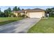 Charming single-story home featuring a well-maintained lawn, a spacious driveway and manicured landscaping at 5955 Ferendina St, North Port, FL 34291