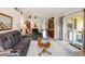 Spacious living area with sliding glass doors, modern furniture, and seamless transition to the kitchen, promoting indoor-outdoor living at 5955 Ferendina St, North Port, FL 34291