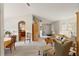 Bright living room featuring neutral carpeting, vaulted ceilings, and an open concept design for flexible living at 5955 Ferendina St, North Port, FL 34291