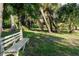 Bench seating in shady park with mature trees, offering a peaceful and relaxing environment at 5955 Ferendina St, North Port, FL 34291