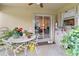 Cozy covered outdoor patio with a ceiling fan, seating, and views of the backyard at 5955 Ferendina St, North Port, FL 34291
