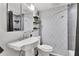 Sleek bathroom featuring a modern vanity, stylish gray wall tiles, and a contemporary mirror for a refreshing ambiance at 6013 Murdock Ave, Sarasota, FL 34231