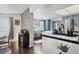 Stylish eat-in kitchen with unique decor, stainless steel appliances, and hardwood floors at 6013 Murdock Ave, Sarasota, FL 34231