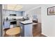Modern kitchen with stainless steel appliances, blue cabinets, and a view into the den at 6013 Murdock Ave, Sarasota, FL 34231