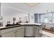 Open concept kitchen featuring an island with white countertops and stainless steel appliances at 6013 Murdock Ave, Sarasota, FL 34231