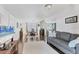 Bright living room with hardwood floors, modern decor, and an open layout to the kitchen at 6013 Murdock Ave, Sarasota, FL 34231