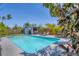 Inviting backyard pool area with a cabana, lounge chairs, and clear blue water at 6013 Murdock Ave, Sarasota, FL 34231