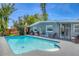 Refreshing pool surrounded by lush landscaping and patio seating, creating a serene escape at 6013 Murdock Ave, Sarasota, FL 34231