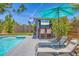 Backyard oasis featuring a pool, lounge chairs, and outdoor bar area for entertaining at 6013 Murdock Ave, Sarasota, FL 34231