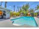 Relaxing backyard pool area featuring a built-in outdoor kitchen and lush tropical landscaping at 6013 Murdock Ave, Sarasota, FL 34231