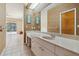Bathroom with a long vanity, a large mirror, and a water closet at 6110 Misty Oaks St, Sarasota, FL 34243