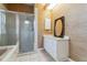 Neutral bathroom featuring a walk in shower, soaking tub and white vanity with granite countertop at 6110 Misty Oaks St, Sarasota, FL 34243