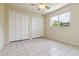 Bedroom featuring tile floors, a ceiling fan, and a window at 6110 Misty Oaks St, Sarasota, FL 34243