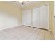Bedroom featuring tile floors, two closets, and a ceiling fan at 6110 Misty Oaks St, Sarasota, FL 34243