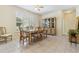 The dining room is bright with natural light and features tile floors and updated light fixtures at 6110 Misty Oaks St, Sarasota, FL 34243
