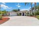 Charming home with a blue front door and a wide driveway at 6110 Misty Oaks St, Sarasota, FL 34243