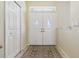 Bright foyer features a decorative glass double door and tile flooring at 6110 Misty Oaks St, Sarasota, FL 34243