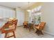 Bright eat-in kitchen with neutral paint, tile floors, and modern lighting at 6110 Misty Oaks St, Sarasota, FL 34243