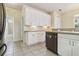 Bright eat-in kitchen with stainless steel appliances, white cabinets and tile flooring at 6110 Misty Oaks St, Sarasota, FL 34243