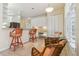 Eat-in kitchen with light cabinets, breakfast bar, and an additional seating area at 6110 Misty Oaks St, Sarasota, FL 34243