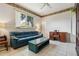 Living room area featuring tile floors, a ceiling fan, and a large window at 6110 Misty Oaks St, Sarasota, FL 34243