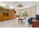 Spacious living room with tile floors and a large built-in at 6110 Misty Oaks St, Sarasota, FL 34243
