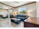 Living room area featuring tile floors, ceiling fan, and nice furniture at 6110 Misty Oaks St, Sarasota, FL 34243
