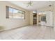 Main bedroom boasts tile floors, ceiling fan, a large window and views of the bathroom at 6110 Misty Oaks St, Sarasota, FL 34243