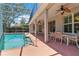 Screened-in pool and patio with ceiling fans and outdoor dining space at 6110 Misty Oaks St, Sarasota, FL 34243