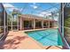 A view of the screened-in pool with a covered patio and ceiling fans at 6110 Misty Oaks St, Sarasota, FL 34243