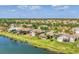 Aerial view showcasing a community by the lake, highlighting the homes and greenery at 6520 38Th E Ln, Sarasota, FL 34243