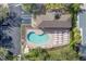 Overhead view of community pool, showcasing a kidney shape with chairs, parking, and lush landscaping at 6520 38Th E Ln, Sarasota, FL 34243