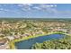 High aerial perspective of a residential area with houses situated near a picturesque lake at 6520 38Th E Ln, Sarasota, FL 34243