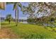 Serene backyard view with a lake and lush green lawn, perfect for relaxation at 6520 38Th E Ln, Sarasota, FL 34243