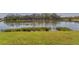 Serene view of the peaceful lake with manicured green grass at 6520 38Th E Ln, Sarasota, FL 34243