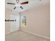 Carpeted bedroom with a ceiling fan, double closet doors, and natural lighting at 6520 38Th E Ln, Sarasota, FL 34243