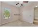 Bedroom with carpet, ceiling fan, and natural light from a large window at 6520 38Th E Ln, Sarasota, FL 34243