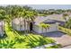 Charming home with lush lawn, mature palms, and a brick driveway offering picturesque curb appeal at 6520 38Th E Ln, Sarasota, FL 34243
