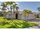 Charming single-story home featuring lush landscaping, stone accents, and a spacious two-car garage at 6520 38Th E Ln, Sarasota, FL 34243