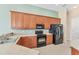 This kitchen boasts ample counter space, black appliances, and lots of wooden cabinets for storage at 6520 38Th E Ln, Sarasota, FL 34243