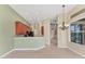 Open-concept kitchen with breakfast bar and a view of the living area and lanai at 6520 38Th E Ln, Sarasota, FL 34243
