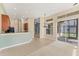Spacious kitchen connecting to the carpeted living room with views of the lanai at 6520 38Th E Ln, Sarasota, FL 34243