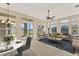 Bright living area with comfortable seating, a chandelier, and sliding glass doors to the lanai at 6520 38Th E Ln, Sarasota, FL 34243