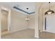 Open-concept living space boasts arched doorways, chandelier, and tile flooring at 6520 38Th E Ln, Sarasota, FL 34243