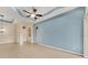 Spacious living room featuring high ceilings, tile flooring, and modern ceiling fan at 6520 38Th E Ln, Sarasota, FL 34243