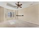 This spacious main bedroom features neutral walls and carpet with large windows to let the sunlight in at 6520 38Th E Ln, Sarasota, FL 34243