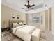 Serene main bedroom showcasing neutral tones, natural light and a cozy seating area at 6520 38Th E Ln, Sarasota, FL 34243