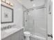 Bright bathroom featuring a marble vanity and a glass enclosed shower at 6611 2Nd Ne Ave, Bradenton, FL 34208