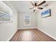 Bright bedroom features wood floors, ceiling fan, and a television for added comfort at 6611 2Nd Ne Ave, Bradenton, FL 34208